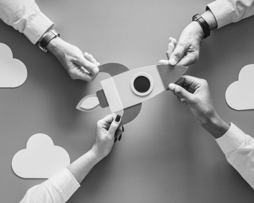 Business people with startup rocket